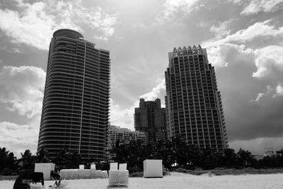 Modern buildings against cloudy sky