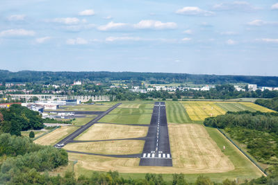 Aerial view of airport runway against sky