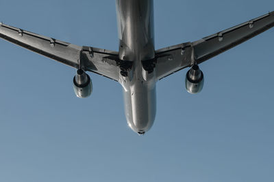 Low angle view of airplane against clear sky