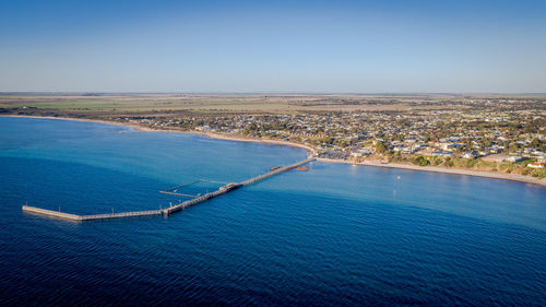 High angle view of sea shore against clear sky