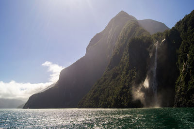 Scenic view of sea and mountains against sky