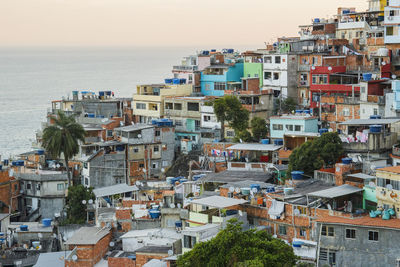 High angle view of townscape by sea against sky