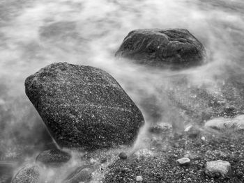 Close-up of stones in waves 