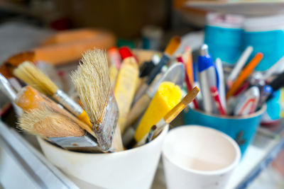 Close-up of paintbrushes in container