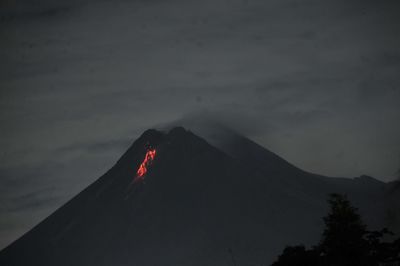 Low angle view of volcanic mountain against sky