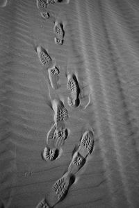 High angle view of footprints on sand at beach