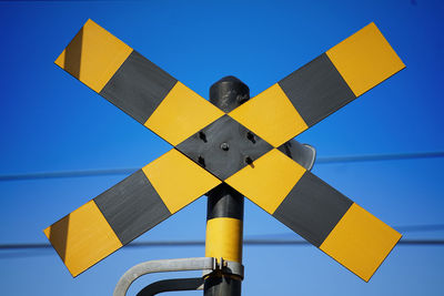 Low angle view of  against railroad crossing sky