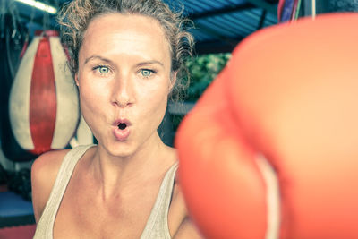 Close-up of young woman wearing boxing glove