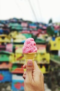 Close-up of hand holding ice cream