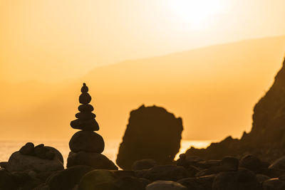 Heap of stones near sea at sunrise. ribeira da janela, madeira