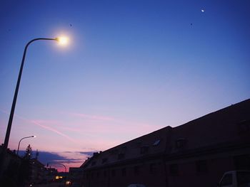 Low angle view of illuminated street light against sky at night