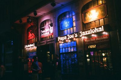 Illuminated sign on building at night