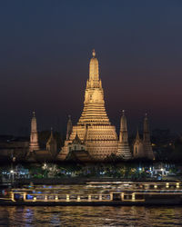 Illuminated building against sky at night