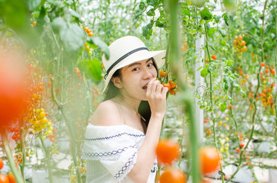 Portrait of young woman wearing hat