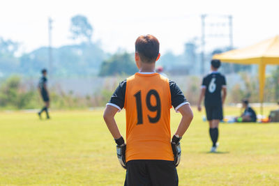 Rear view of man standing on field