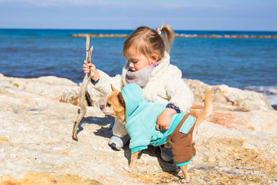 Full length of boy holding toy on beach