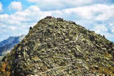 Low angle view of rocks on mountain against sky