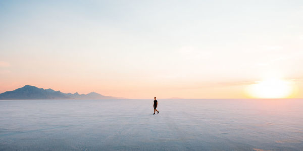Full length of man walking on land during sunset