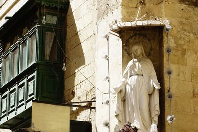 Statue of buddha against building