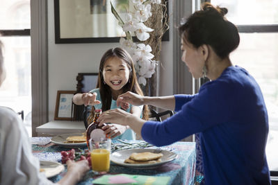 Happy family enjoying breakfast on birthday