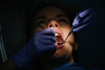 Dentist examining pregnant woman in clinic