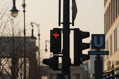 Close-up of road sign against sky