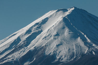 Scenic view of snowcapped mountains against clear sky