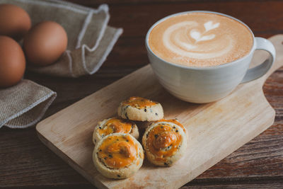 High angle view of coffee and cookies on table