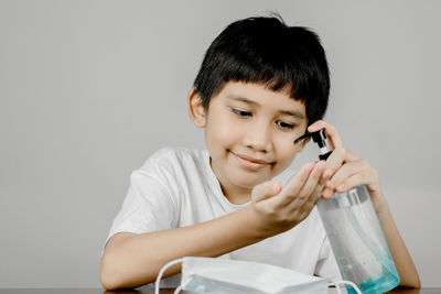 Portrait of boy sitting on table