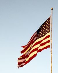 Low angle view of flag against clear sky