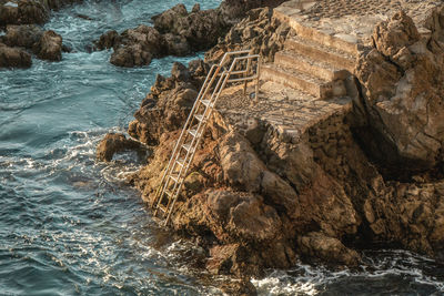 High angle view of rock formation in sea