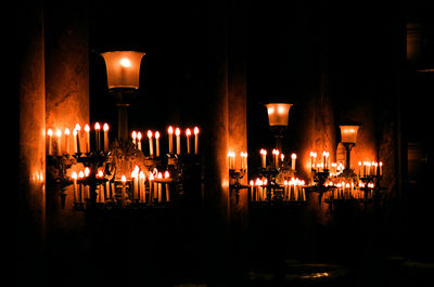 Illuminated candles in temple at night