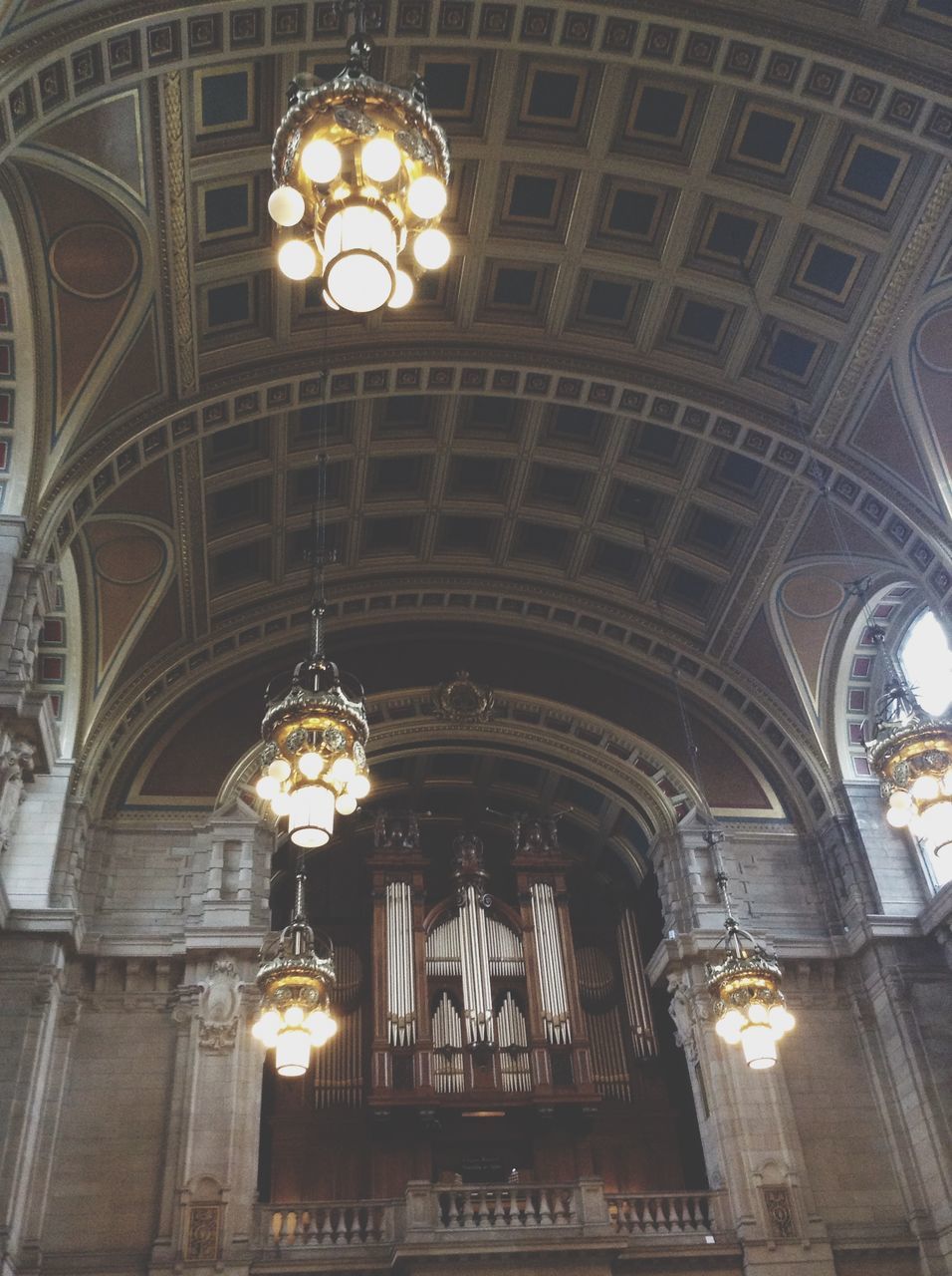 architecture, indoors, low angle view, built structure, place of worship, religion, illuminated, church, ceiling, spirituality, lighting equipment, arch, cathedral, chandelier, ornate, hanging, interior, electric lamp