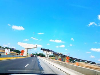 Road against blue sky in city