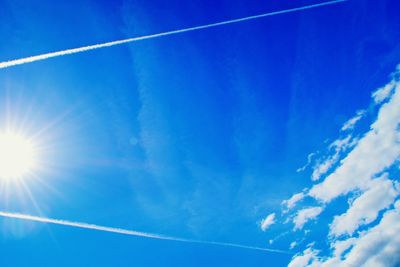 Low angle view of vapor trail in blue sky