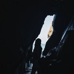 Silhouette of man standing on rock