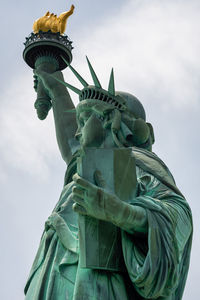 Low angle view of statue of liberty against sky