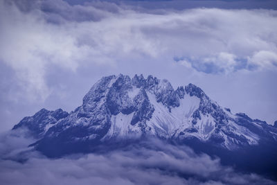 Low angle view of snowcapped mountain against sky