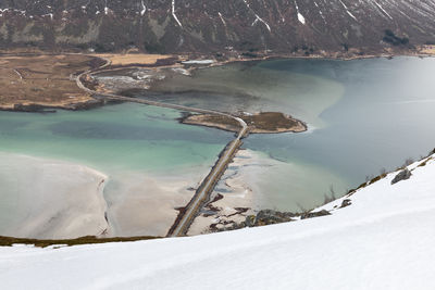 High angle view of snowcapped mountain by lake