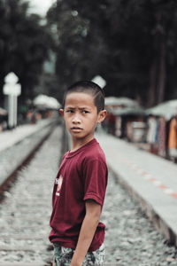 Portrait of cute boy standing in river