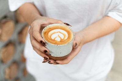 Close-up of woman holding coffee cup