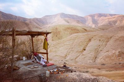 Man relaxing on landscape against mountains