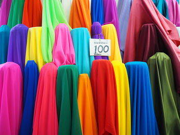 Full frame shot of colorful fabrics with label at market stall