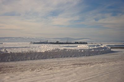 Scenic view of land against sky during winter