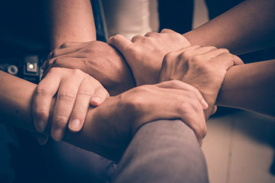 Cropped image of friends with holding hands