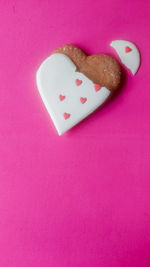 High angle view of heart shape on pink cake