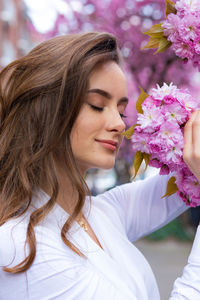 Portrait of beautiful woman with red flower
