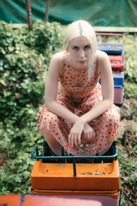 Portrait of young woman sitting on miniature train