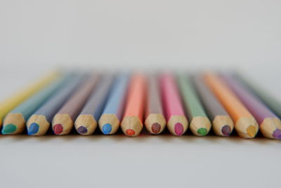 Close-up of colored pencils against white background