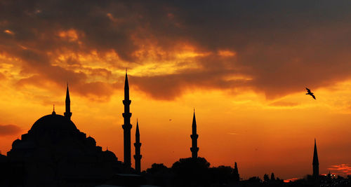 Mosque silhouetted against golden sunset